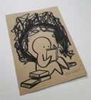 Cartoon character reading a book on kraft paper with scribbles above its head.