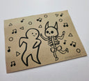 Black marker illustration on brown paper of a character dancing with a skeleton with music notes around.