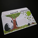 Illustration on a paper envelope of a tree with various characters and cats around.