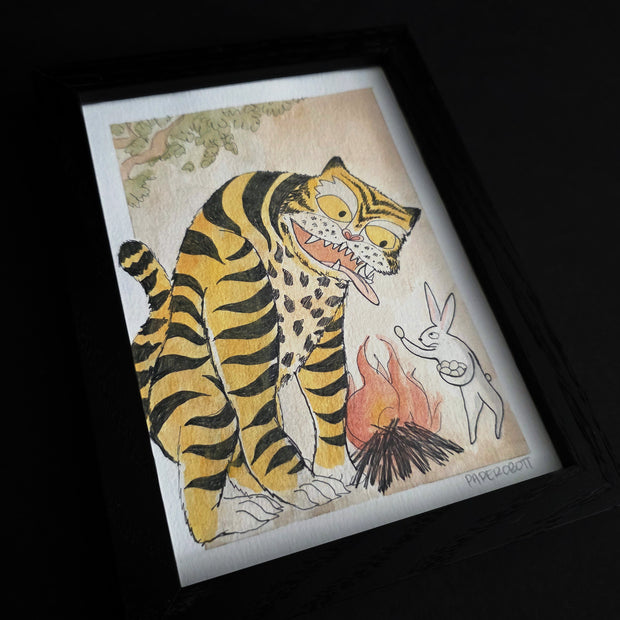 Framed artwork of a tiger and rabbit, sharing food over a bonfire.