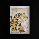 Framed artwork of a tiger and rabbit, sharing food over a bonfire.