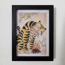 Framed artwork of a tiger and rabbit, sharing food over a bonfire.