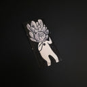 A rectangular drawing featuring a stylized white figure with a flower-like head, photographed on a dark black background.