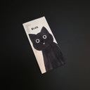 A rectangular drawing featuring a black cat illustration on a white background, photographed on a dark black surface. The word 'BLEH.' is on the top of the drawing.