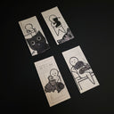 Set of 4 black marker drawings on thin strips of white paper, of a simplistic white character interacting with cats.