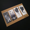 Set of 4 black ink illustrations on thin white strips of paper of a simplistic white character in scary situations.
