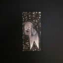 A small rectangular black-and-white drawing featuring a stylized ghost-like figure with a circular head and triangular shape, centered on a dark background.