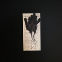 A drawing of a simplistic small character with large black plumes of smoke coming out of its eyes.