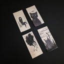 Four rectangular drawings arranged in a 2x2 grid on a black background, each featuring hand-drawn black ink illustrations on off-white paper with text and whimsical cat-themed artwork.