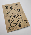 Artistic drawing on a kraft paper background with text and eyes around a central figure.