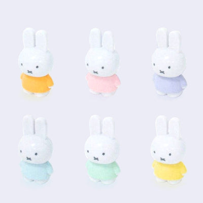 6 standing Miffy figures with their hands at their sides and each wearing a different colored pastel shirt. Colors are: orange, pink, purple, blue, green and yellow.