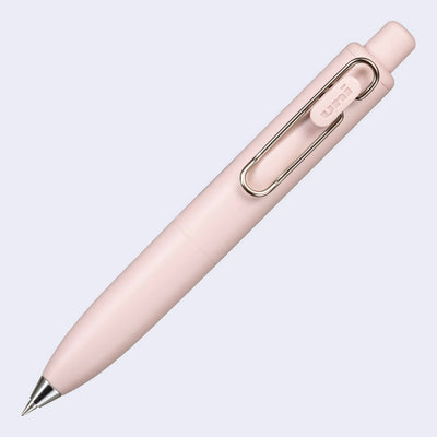 Thick, short peach colored pen with a side clip and a silver pen opening.