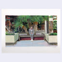 Man in a suit sitting on a bench in an outdoor mall setting with palm trees and buildings.