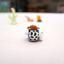 Toy figure with a cowboy hat on a white surface