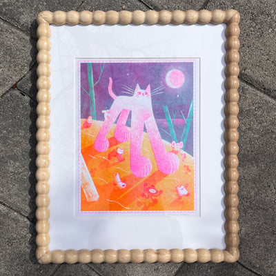 Risograph print of a pink and white cat with giant paws and very large legs, seen from slightly under. It walks on orange ground with tiny characters running alongside it.