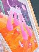 Risograph print of a pink and white cat with giant paws and very large legs, seen from slightly under. It walks on orange ground with tiny characters running alongside it.