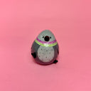 Small ceramic figure of a rounded, chubby gray bird with a vase opening atop its head.