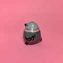 Small ceramic figure of a rounded, chubby gray bird with a vase opening atop its head.
