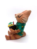 Sculpture of a cartoon style orange tabby cat, sitting with its legs out in front and eyes closed. It holds a pińa colada in its paws and wears a Hawaiian shirt. Viewed from the side.
