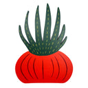 A stylized decorative cutout shaped like a succulent plant, with a bright red rounded base and dark green spiky leaves outlined in pale yellow, shown on a plain white background.