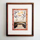 Artwork of 2 whimsical illustrated kittens holding flower stems, mountains in the background and an orange bird flying between them. Below them is a separate drawn panel of a house with an overgrown garden and a star flying overhead. Piece is framed in a wooden frame.