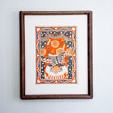 A stylized illustration of a white cat wearing a striped shirt and fabric collar, with a butterfly flying across its face, set against an orange and black theatrical curtain background with decorative border motifs including stars, hearts, and swirls. Piece is housed in wooden frame.