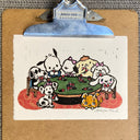 Linocut print of a group of cartoon dogs playing poker, at a green table.