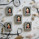 5 similar looking cement boxes, each with a sun goddess looking character inside.