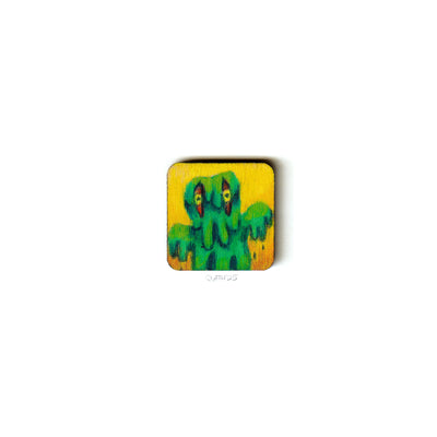 Small wooden panel with an illustration of Hedorah, a green goo monster.