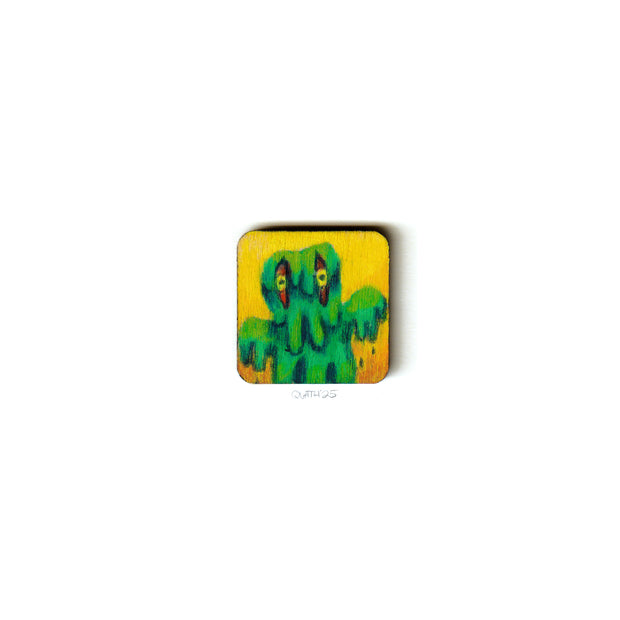 Small wooden panel with an illustration of Hedorah, a green goo monster.