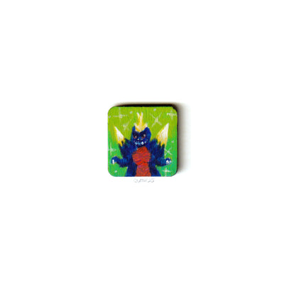Small wooden panel with illustration of a blue Godzilla like monster on green background.