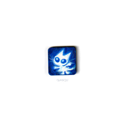 Very small square wooden panel with an illustration of a white cartoon cat on a blue background.