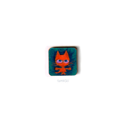 Very small square wooden panel with an illustration of a cartoon cat on a blue background.
