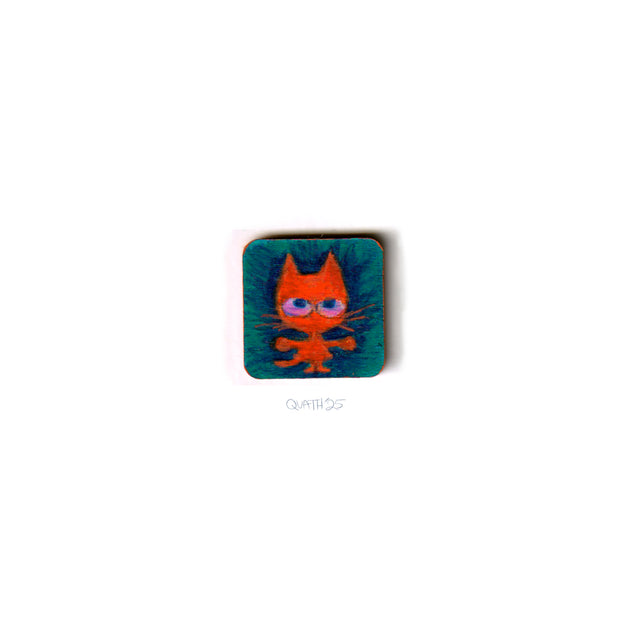 Very small square wooden panel with an illustration of a cartoon cat on a blue background.