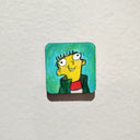 Illustration on a tiny panel of a yellow cartoon character, Ed from Ed Edd n Eddy