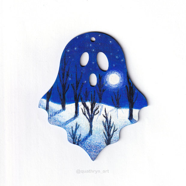 Ghost shaped wood panel with an illustration of a forest at night in the winter, with bare trees, snow on the ground and a glowing moon against a dark blue sky.