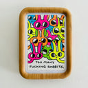 Framed drawing of many colorful cartoon rabbits with simple, large eyes and text at the bottom that reads "Too many fucking rabbits."