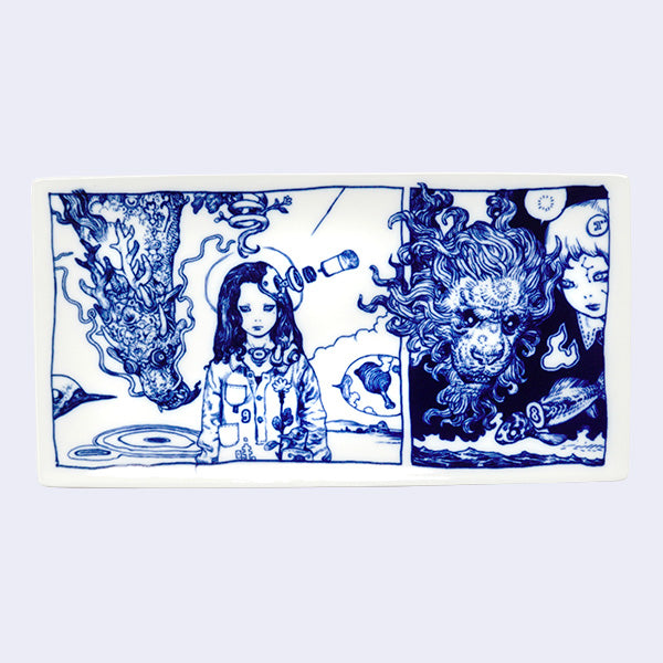 Rectangular white porcelain plate with dark blue line art illustrations of 2 scenes, divided like a comic panel. Left scene depicts a person with long hair and robotics coming out of their head. A dragon flies down behind them. Right scene is of a lion head, with a fierce mane and the solemn face of a girl.