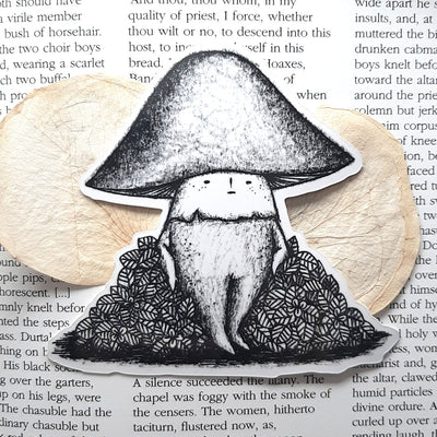 Black and white sticker of a mushroom with a small cartoon face standing and resting on a bush.