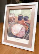 Still life illustration of a fancy pastry cafe, with a cream puff and cake on a plate with coffee behind it. Piece is framed.