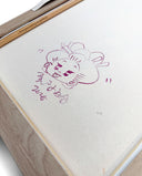 Backside of a framed canvas with a doodle by the artist.