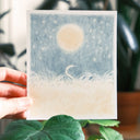 Colored pencil illustration of a snake within a large series of grass under a big glowing moon.