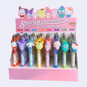 Display case featuring 8 different pens with Sanrio characters on the pen clip. Each has a different ink color.