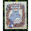 Illustration of Totoro, looking at the viewer with a surprised expression. A decorative border made of illustrated branches and flowers frames him.
