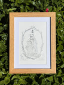 Graphite illustration on gray paper of a fox in a suit standing next to a tree stump with branches forming an arch above. Piece is in a wooden frame.