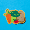 Die cut sticker of a group of cartoon style vegetables: a carrot, broccoli, tomato and potato.