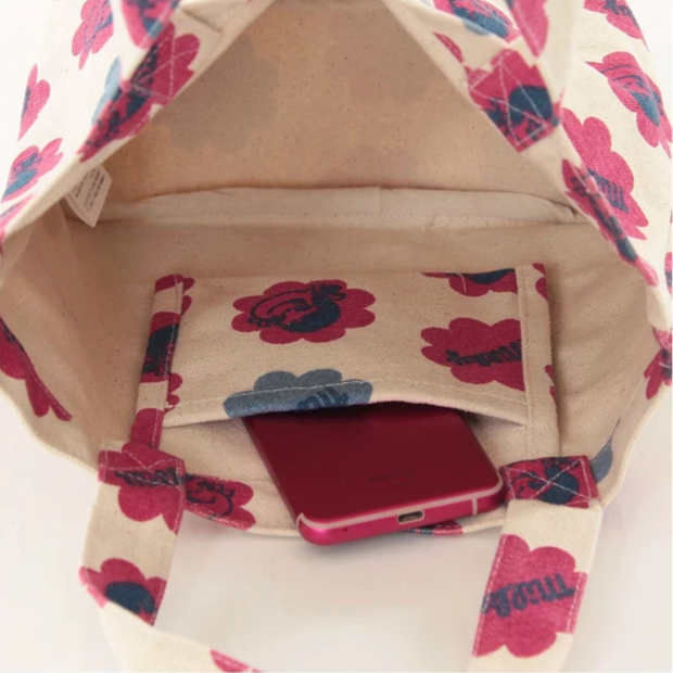 Inside view of canvas purse, with a small inner pocket.