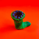 Vinyl worm character with an open mouth, taking place of any head, with sharp purple teeth.