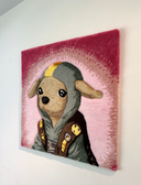 Rug tufting artwork of a cute cartoon brown chihuahua, wearing a hooded jacket with a yellow strip on it and a harness of sorts. Background is bright pink.