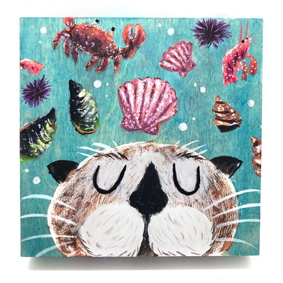 Painting of teal underwater setting with various shells, a crab and a shrimp floating around. At the bottom of the piece is a cartoon otter with its eyes closed but a satisfied expression. It can only be seen from the cheeks up.